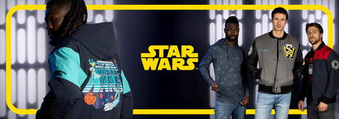 four-individuals-wearing-jackets-with-star-wars-branding-against-a-dark-background