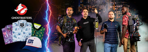 a-promotional-ghostbusters-themed-collage-with-four-men-standing-in-a-dramatic-dark-city-scene-with-lightning-and-smoke-effects-alongside-product-images-including-a-ghostbusters-logo-patterned-shirts-a-cap-and-proton-packs