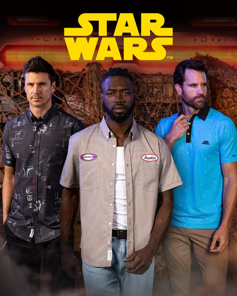 three-men-standing-in-front-of-a-star-wars-themed-backdrop-with-the-star-wars-logo-at-the-top-the-man-in-the-center-wears-a-rsvlts-beige-short-sleeve-button-up-shirt-with-two-visible-star-wars-logos-while-the-man-on-the-left-wears-a-dark-patterned-shirt-and-the-man-on-the-right-wears-a-bright-blue-polo-shirt