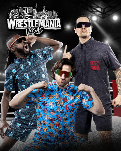 promotional-banner-for-wrestlemania-vegas-with-three-people-posing-in-front-of-a-boxing-ring-setup-wearing-rsvlts-wwe-shirts